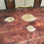 Molten Gold Pedestal Dining Table with Deep Red Burl Wood Top and Inlaid Motif